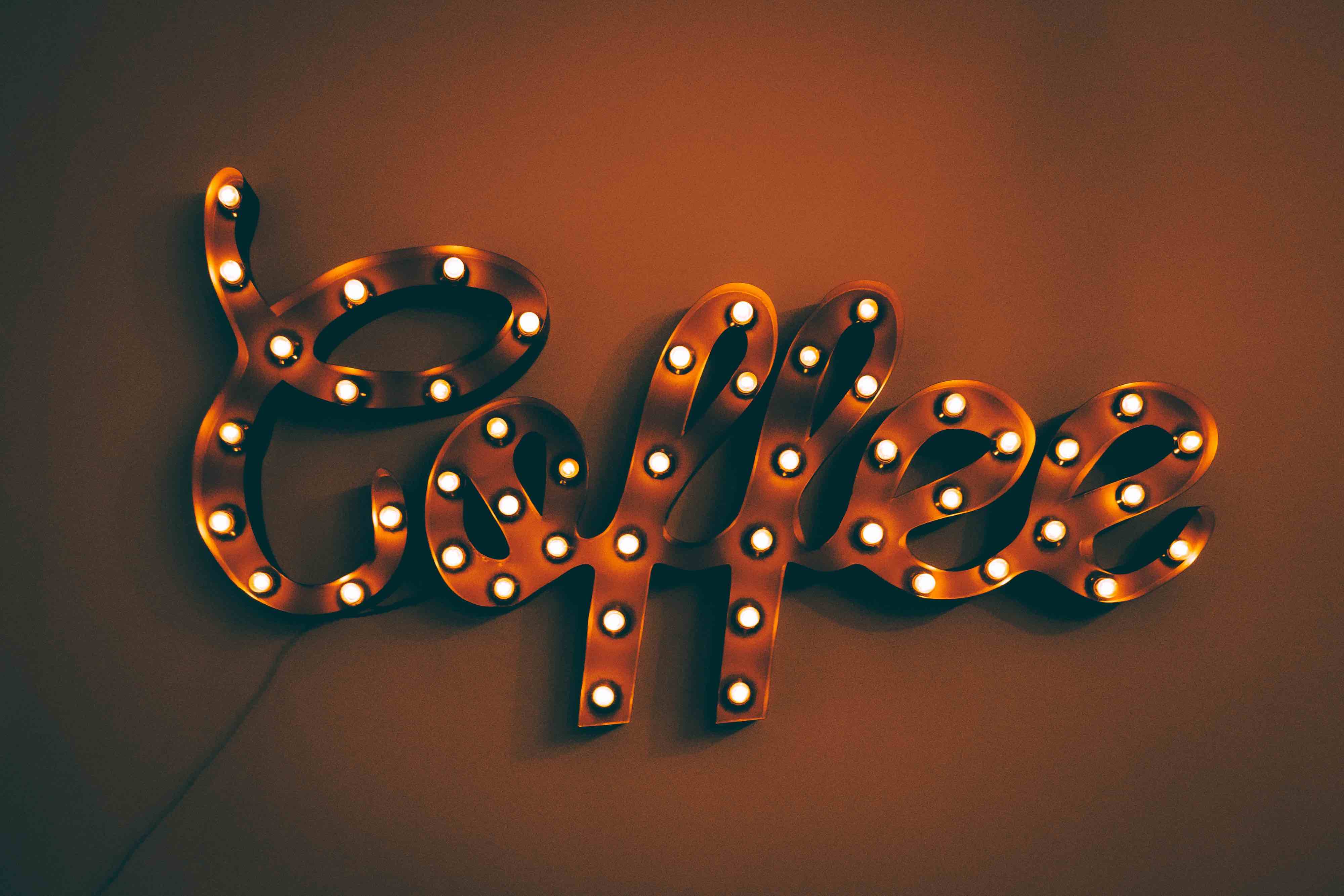 An electrical coffee sign mounted on a wall.