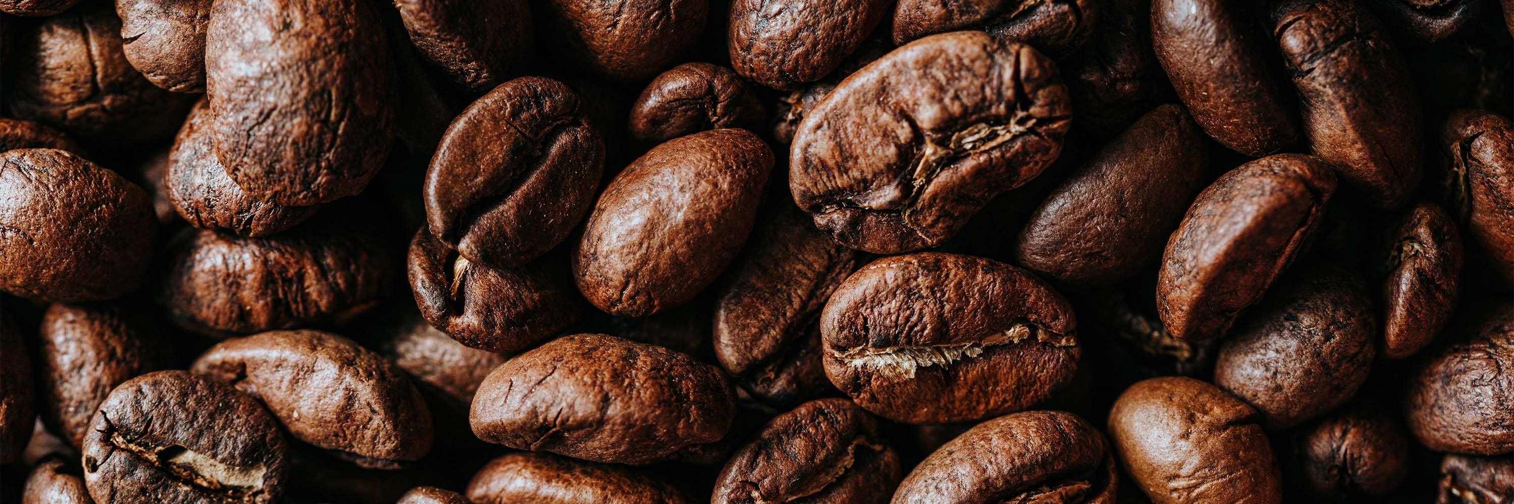 Wide close up image of coffee beans.